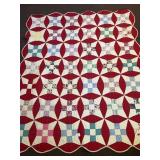 A hand-stitched quilt. It measures approximately