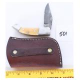 A small Damascus blade folding knife with sheath