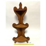 A small wooden corner shelf can be used for
