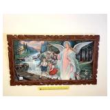 A vintage angel print in ornate wooden frame. -