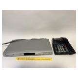 A Daewoo DVD player and an adding machine -