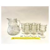 A pitcher and glass set. It