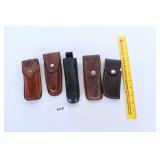 A group lot of knife cases and sheets - one is a