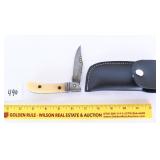 A Damascus folding knife with sheath