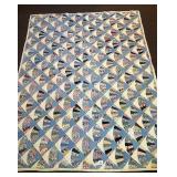 A hand-stitched quilt fan pattern. It measures