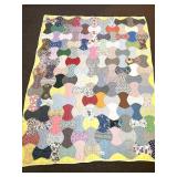 A hand-stitched quilt measures approx. 61 x 78