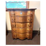 An antique oak dresser on casters. It measures
