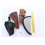 A group lot of gun holsters and a gun case