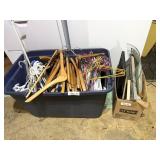 Tote full of wooden, plastic, and metal clothes