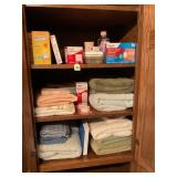 CONTENTS OF CABINET IN BATHROOM - TOWELS, BAND-AID