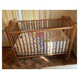 BABY CRIB WITH STUFFED ANIMALS AND BEDDING