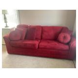 RED UPHOLSTERED HIDE A BED COUCH - 85" LONG