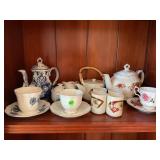 LARGE LOT OF PORCELAIN TEA POTS, CUPS, SAUCERS,