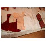 Box of doll clothes and a doll high chair with a