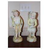 Porcelain bisque boy and girl figurines each with