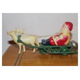 Santa Claus in a sleigh being pulled by a