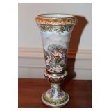 Vase decorated with raised cherubs marked with