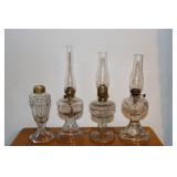 4 Miniature clear glass oil lamps one is Bullseye