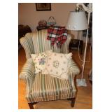 Wingback chair with pillows and a wrought iron