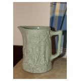 Relief molded stoneware jug with flowers or