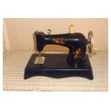 Miniature childs sewing machine decorated with