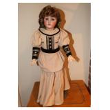 Old doll with porcelain face and jointed arms and