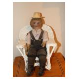 Old cloth doll with wicker chair