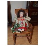 Doll with porcelain face and jointed arms and