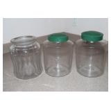 2 Handblown glass jars with green metal lids and