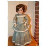Doll with porcelain face and jointed arms and
