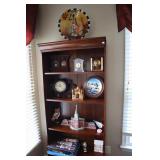 Contents of bookcase (clocks, decortive plates,