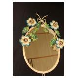 Oval mirror with metal flowers around the edge