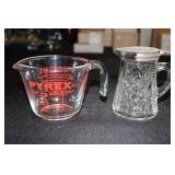 Clear glass syrup dispenser and a Pyrex measuring