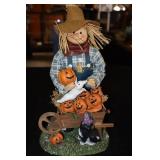 Halloween Scarecrow with pumpkins in cart