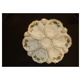 Floral design oyster plate marked with an X on