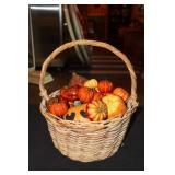 Wicker handled basket with decorative pumpkins