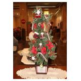 Small lighted artificial Christmas tree with