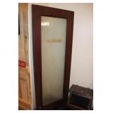Wooden telephone booth door with frosted glass
