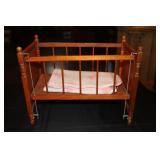 Doll crib with a bunny baby blanket