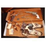 Cowpoke cap guns with holsters and arm cuffs,
