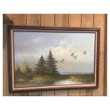 Framed painting of flying mallards over marsh by