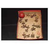 Box containing 22 old jacks and a wooden ball