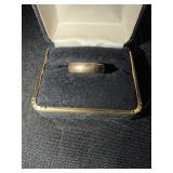Gold wedding band marked 14 with a sideways