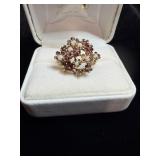 Ring with red and white gem stones marked 375 DMJ