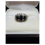 Ring with black and small clear gem stones