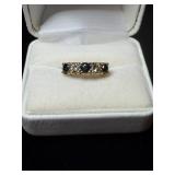 Ring with dark blue/black and clear gem stones