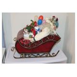 Santa Claus figurine in a metal sleigh