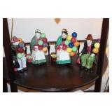 Shelf lot - 4 figurines of people holding