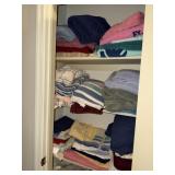 Linen closet containing towels and comforters