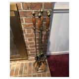 Brass fireplace tools with wooden handles and